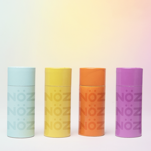 four NOZ sunscreen tubes in blue, yellow, orange, and purple